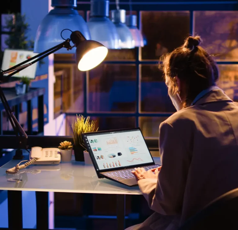 Startup worker checking financial data report online with diagrams late at night, helping to increase profit. Female entrepreneur working on economy investment with statistics. Handheld shot.